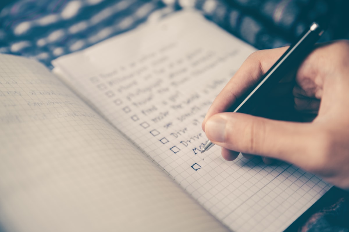 Person reviewing a job search checklist at a desk